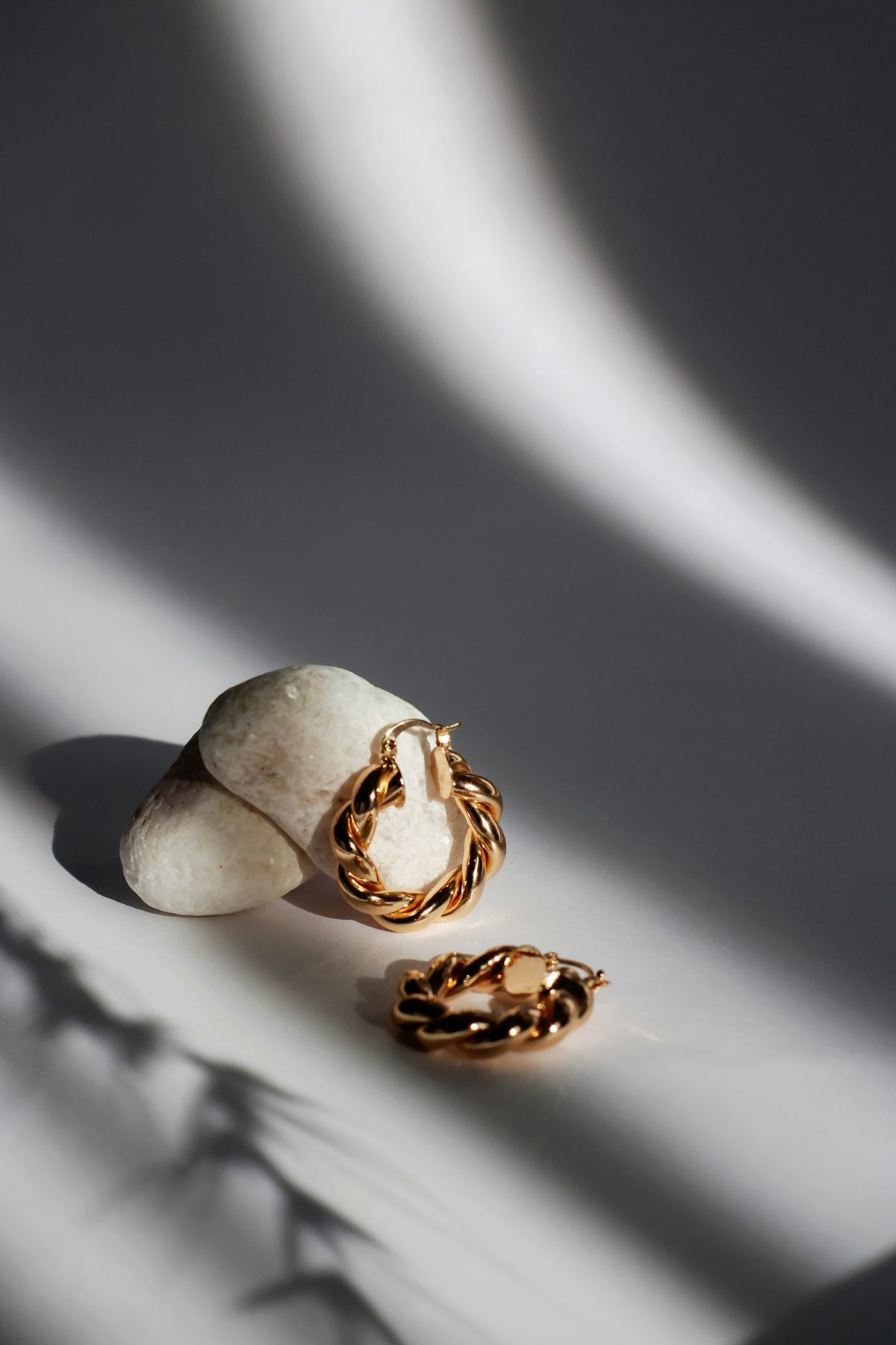 Jeweller's bench close-up — gold tools, a half-set ring on a forming peg